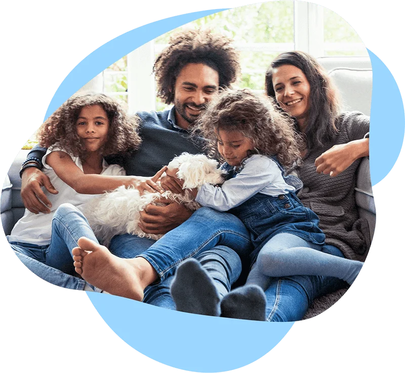 Family relaxing and playing with their puppy