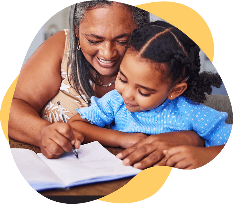Mother showing her young daughter her writing